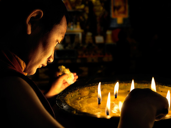 Monk and butter lamp