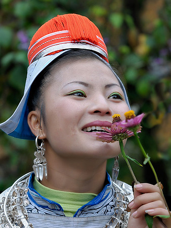 Gejia girl smelling flowers