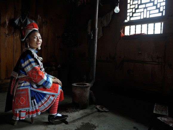 Gejia girl at wood stove